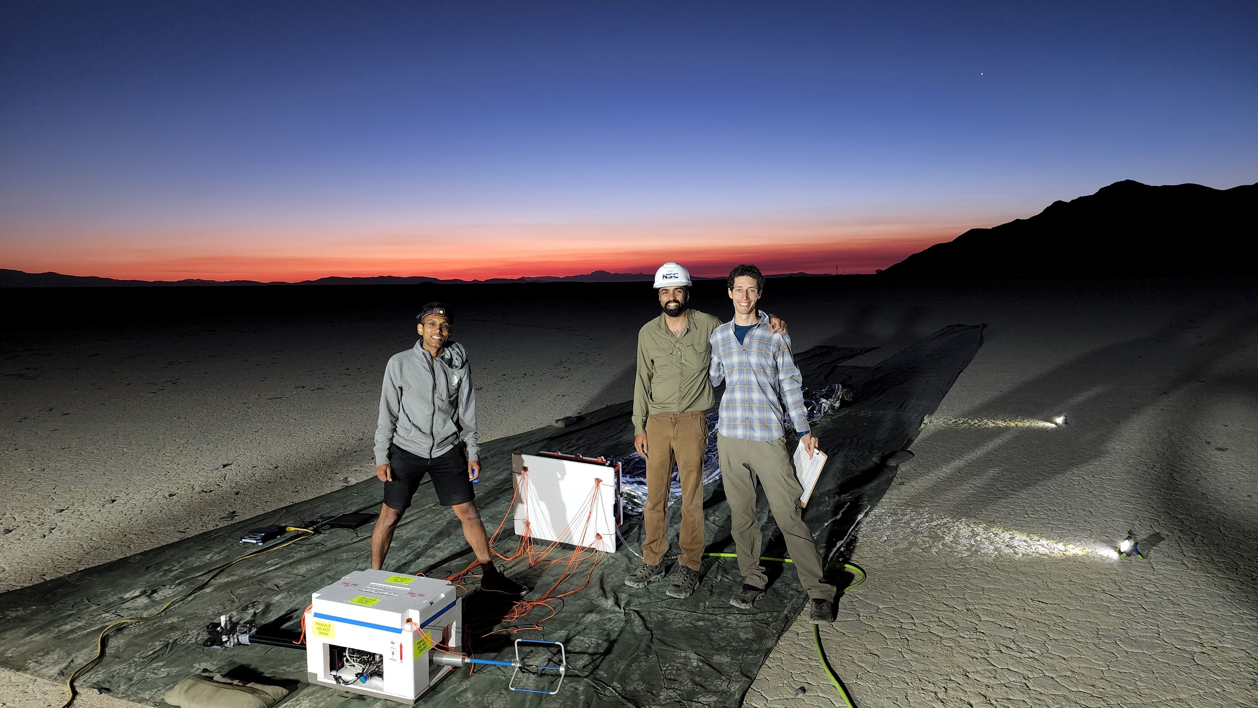 Picture: [Left to right] Ashish Goel (JPL), Siddharth Krishnamoorthy (JPL), and Jacob Izraelevitz (JPL) set up the aerobot prototype as the planet Venus rises in the Eastern sky.