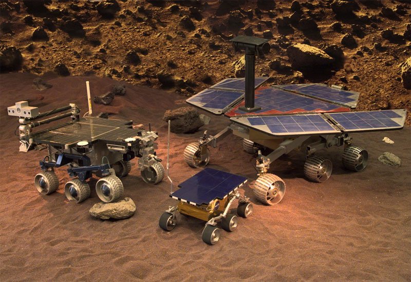 Fig. 2: A view of one PRL test area, showing the FIDO rover (left) next to models of the Sojourner and MER rovers (center and right, respectively).